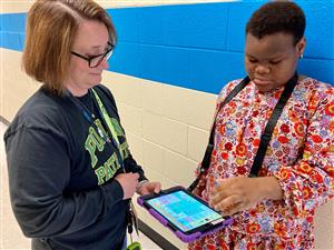 Poplin student using an iPad and app to communicate